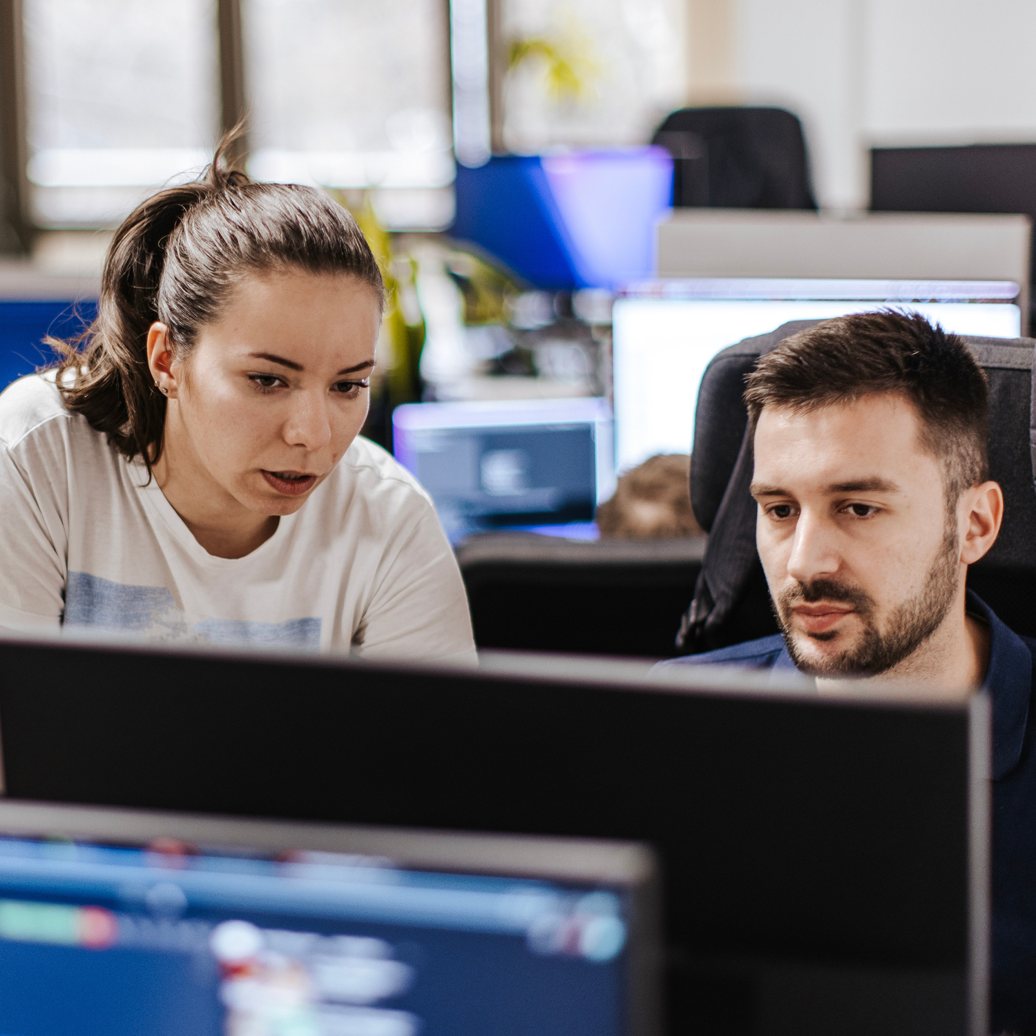 Photo of a man and woman looking at a computer screen together