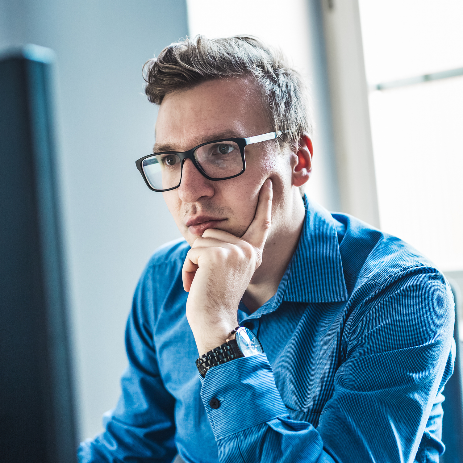 Photo of a man looking at a computer screen